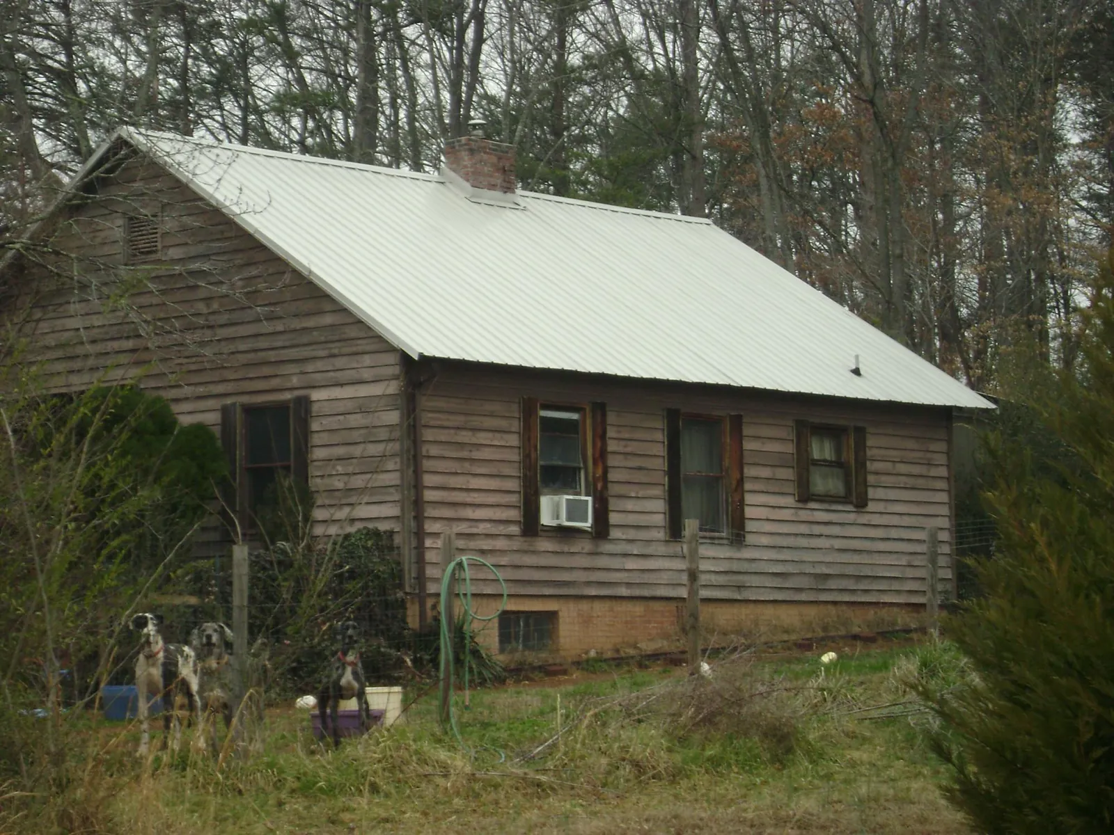 White metal roof on an old wood sided farmhouse, from a Asphalt Shingle Roof Repair job in Liberty Mills